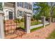 Charming front yard with brick walkway, wrought iron gate, and lush landscaping leading to the inviting front entrance at 3890 The Battery, Duluth, GA 30096
