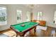 Bright game room boasts a pool table, comfortable seating, and ample natural light from large windows at 3890 The Battery, Duluth, GA 30096