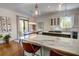 Bright kitchen with a marble island, stainless steel appliances, and a dining area with modern lighting at 3890 The Battery, Duluth, GA 30096