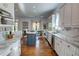 Bright and airy kitchen featuring white cabinets, marble countertops, and hardwood floors, flowing into the dining room at 3890 The Battery, Duluth, GA 30096