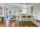 Modern kitchen with a dining area, white cabinets, marble countertops, and stainless steel appliances at 3890 The Battery, Duluth, GA 30096