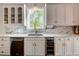 Modern kitchen with white cabinetry, marble backsplash, stainless steel appliances, and a wine refrigerator at 3890 The Battery, Duluth, GA 30096