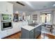 Open-concept kitchen with marble countertops, stainless steel appliances, a center island, and a dining area at 3890 The Battery, Duluth, GA 30096