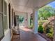Charming front porch with brick flooring, bench seating, and a view of the lush front yard and garden at 3890 The Battery, Duluth, GA 30096