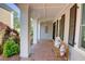 Inviting front porch with brick flooring, comfortable seating, and views of the landscaped yard and neighborhood at 3890 The Battery, Duluth, GA 30096