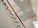 Beautiful staircase with detailed trim, designer chandelier, and recessed lighting leading to the upper level at 3890 The Battery, Duluth, GA 30096