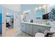 Bathroom featuring dual sinks, marble countertops, tiled floors, and framed mirrors at 436 Suwanee East Dr, Lawrenceville, GA 30043