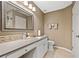 Bathroom with a single sink, white cabinets, framed mirror, and tiled floors at 436 Suwanee East Dr, Lawrenceville, GA 30043