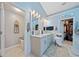 Bright bathroom with dual sinks, marble countertops, tiled floors, walk-in closet, and linen closet at 436 Suwanee East Dr, Lawrenceville, GA 30043