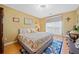 Bedroom with a queen bed, wood floors, large window, and computer desk at 436 Suwanee East Dr, Lawrenceville, GA 30043