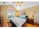 Bedroom with a queen bed, wood floors, high ceilings, large window and built-in dresser at 436 Suwanee East Dr, Lawrenceville, GA 30043