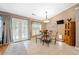 Eat-in kitchen area with backyard access, tile floors, glass table and cabinet, plus natural light at 436 Suwanee East Dr, Lawrenceville, GA 30043