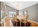 Cozy dining room featuring wood floors, cabinet, and plenty of natural light from large window at 436 Suwanee East Dr, Lawrenceville, GA 30043