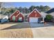 Charming red brick home with well-maintained landscaping and a two-car garage at 436 Suwanee East Dr, Lawrenceville, GA 30043