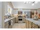 Well-equipped kitchen featuring stainless steel appliances, a tile backsplash, and granite countertops at 436 Suwanee East Dr, Lawrenceville, GA 30043