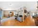 Open-concept living space with hardwood floors, a decorative fireplace, and seamless flow to kitchen and dining area at 436 Suwanee East Dr, Lawrenceville, GA 30043