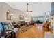 Open living room features hardwood floors, a ceiling fan, various seating options and a fireplace at 436 Suwanee East Dr, Lawrenceville, GA 30043