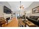 Spacious living room features hardwood floors, ceiling fan, fireplace, and multiple seating options at 436 Suwanee East Dr, Lawrenceville, GA 30043
