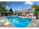 Inviting backyard featuring a sparkling blue pool, lounge chairs, and a covered dining area at 436 Suwanee East Dr, Lawrenceville, GA 30043
