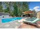 Spacious pool area with sun loungers, umbrella coverage, and beautiful landscaping at 436 Suwanee East Dr, Lawrenceville, GA 30043