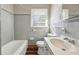 Bathroom featuring a combination tub and shower, with a light color tiled surround at 8586 Taylor Rd, Riverdale, GA 30274