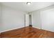 Bedroom featuring hardwood floors, neutral walls, and a closet for storage at 8586 Taylor Rd, Riverdale, GA 30274