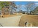 Inviting brick home featuring a long driveway and covered carport for convenient parking at 8586 Taylor Rd, Riverdale, GA 30274