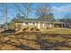Charming brick home with a covered parking area and a well-maintained front yard at 8586 Taylor Rd, Riverdale, GA 30274