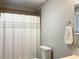 Bathroom with a shower, toilet, decorative towel, and a well-lit mirror at 106 Creek Crossing Ln, Temple, GA 30179