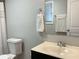 Bathroom includes a neutral countertop sink, toilet, decorative towels, and a well-lit mirror at 106 Creek Crossing Ln, Temple, GA 30179