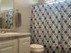 Well-lit bathroom with cultured marble countertops and patterned shower curtain at 106 Creek Crossing Ln, Temple, GA 30179
