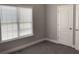 Bedroom featuring new carpeting and a double window at 106 Creek Crossing Ln, Temple, GA 30179