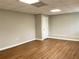 Bedroom features wood-look floors, neutral walls, bright lighting, and a convenient closet at 106 Creek Crossing Ln, Temple, GA 30179