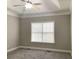 Bedroom featuring a tray ceiling, ceiling fan, and large window with natural light at 106 Creek Crossing Ln, Temple, GA 30179