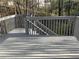 Deck with wood planks and gray wooden railing with wooded background at 106 Creek Crossing Ln, Temple, GA 30179