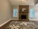 Bright living room with a stone fireplace, hardwood floors, and plenty of space for entertaining guests at 106 Creek Crossing Ln, Temple, GA 30179