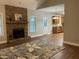 Open floor plan showcasing a stone fireplace, hardwood floors, and seamless transition to the kitchen at 106 Creek Crossing Ln, Temple, GA 30179