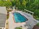 Aerial view of community pool featuring sun loungers and green space with an outdoor fireplace and patio area at 120 Chastain Nw Rd # 608, Kennesaw, GA 30144