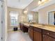 Bathroom featuring a double sink vanity, tiled floors, and a window at 120 Chastain Nw Rd # 608, Kennesaw, GA 30144
