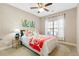 Bedroom with a ceiling fan, window with curtains, and a bed with colorful pillows at 120 Chastain Nw Rd # 608, Kennesaw, GA 30144