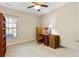 Bedroom showing a window, a ceiling fan, and a wood desk and cabinet at 120 Chastain Nw Rd # 608, Kennesaw, GA 30144