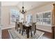 Bright dining room with a chandelier, large windows and a wooden table with chairs at 120 Chastain Nw Rd # 608, Kennesaw, GA 30144
