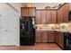 Kitchen with dark cabinetry, granite countertops and black appliances at 120 Chastain Nw Rd # 608, Kennesaw, GA 30144