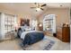 Spacious main bedroom featuring a large window, ceiling fan and comfortable bed at 120 Chastain Nw Rd # 608, Kennesaw, GA 30144