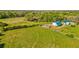 Scenic view of farmland with a large barn surrounded by lush green pastures and trees at 1288 Reavesville Rd, Bowdon, GA 30108