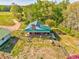 Expansive aerial view of a home with green metal roof and a well-manicured lawn at 1288 Reavesville Rd, Bowdon, GA 30108
