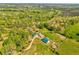 Overhead image displays a charming countryside estate with well-kept farm buildings and vibrant green fields at 1288 Reavesville Rd, Bowdon, GA 30108