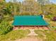 An aerial shot of a home featuring a large green roof and wrap around porch at 1288 Reavesville Rd, Bowdon, GA 30108