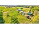 An aerial view of the property highlighting the vast land and outbuildings surrounding the home at 1288 Reavesville Rd, Bowdon, GA 30108