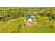 Exterior aerial view of a well-maintained barn with green roof amidst a lush green landscape at 1288 Reavesville Rd, Bowdon, GA 30108